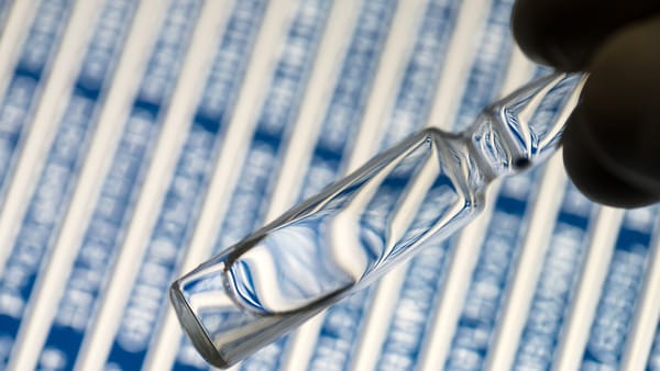 A vial of peptides with chains of amino acids in the background