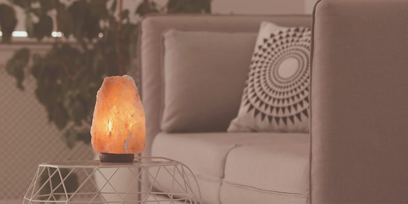A Himalayan salt lamp glowing with a warm amber light