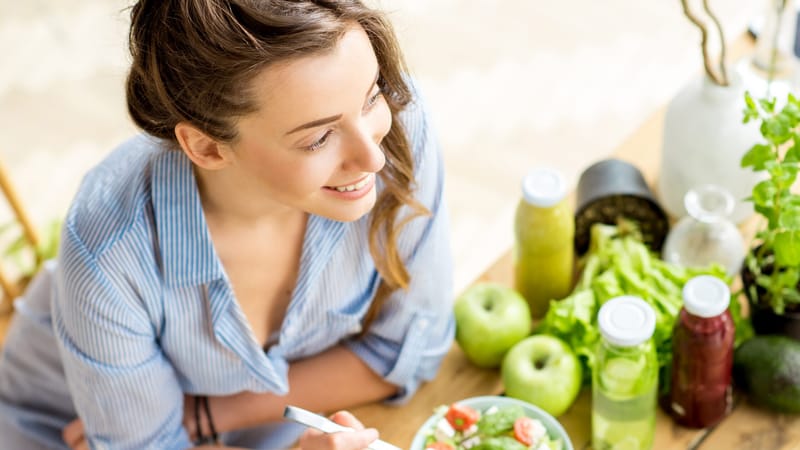 A woman with healthy foods on her counter