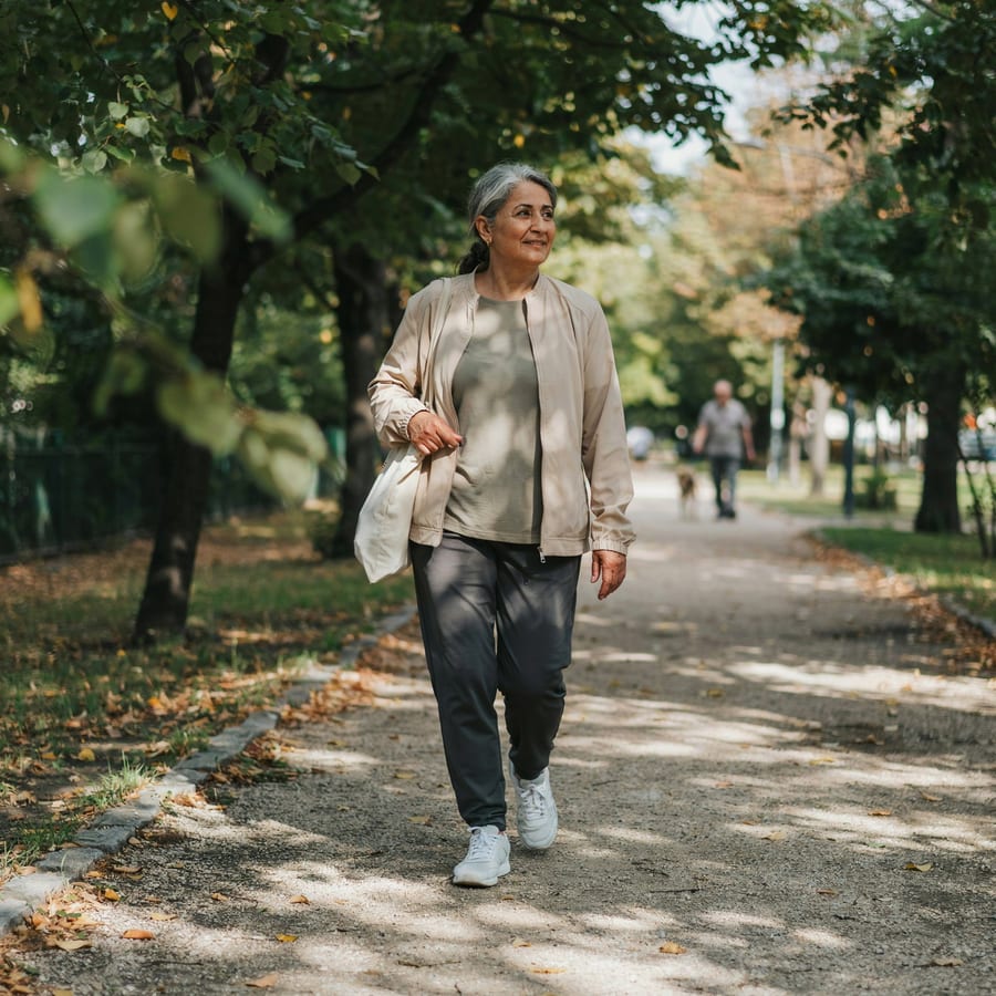 A healthy, energetic woman walking in the park