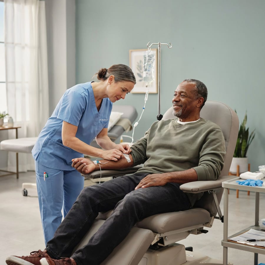 A nurse adjusting an IV for a comfortable patient