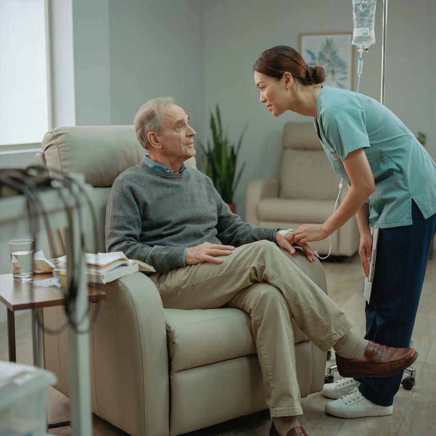 A nurse checking a patient during an IV infusion