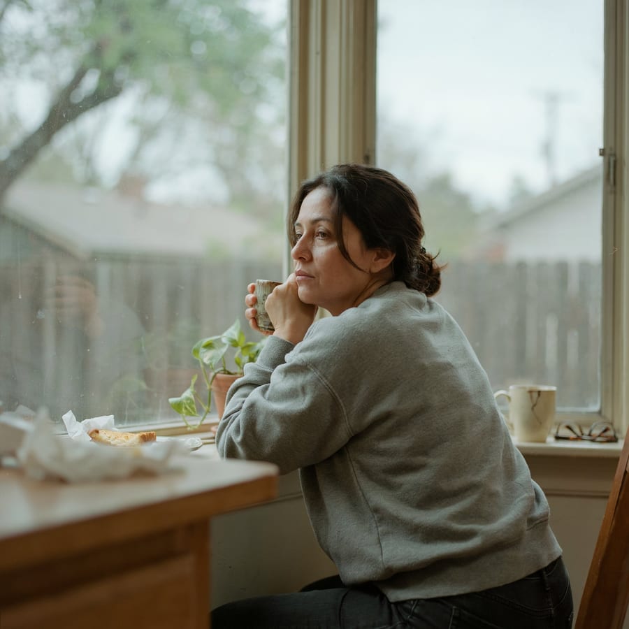 A pensive woman looking out a window