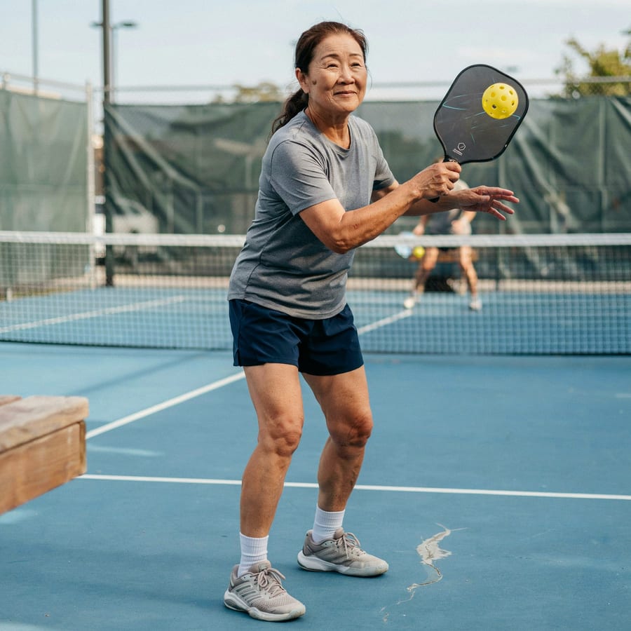 A woman playing pickleball outdoors